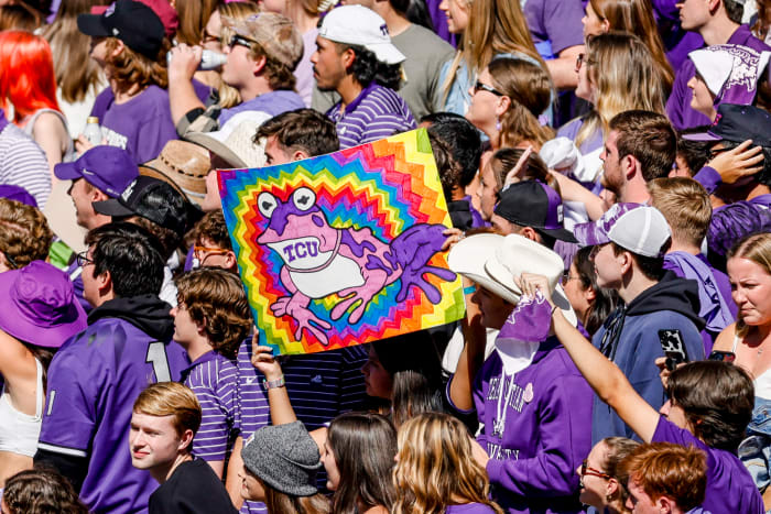 A fan holds up a Hypnotoad sign at a TCU home game.